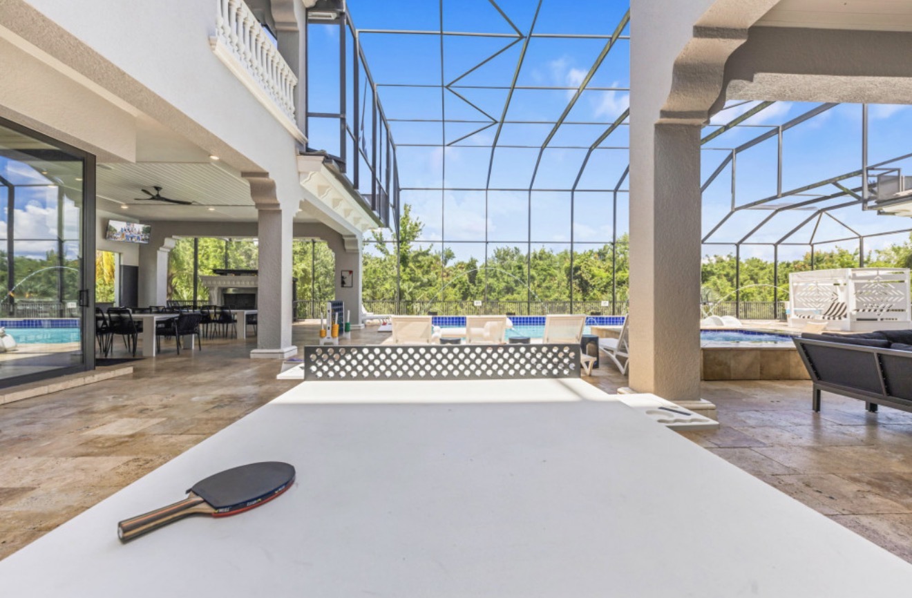 Covered outdoor game area overlooking the pool