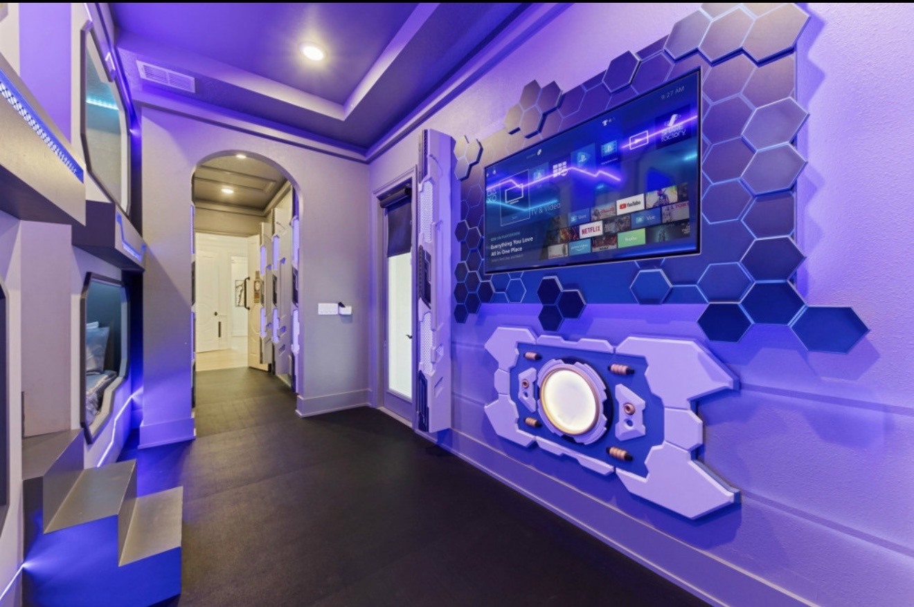Marvel-themed media room with television and illuminated wall details